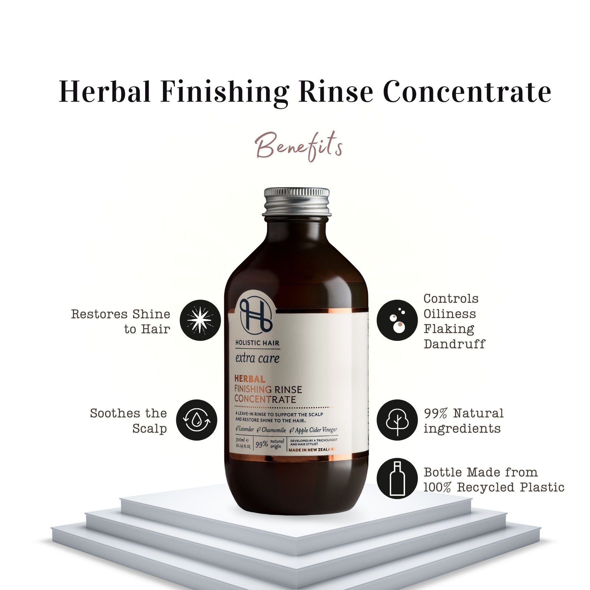 Bottle of leave-in rinse with apple cider vinegar, lavender sprigs, and chamomile flowers on a light background.
