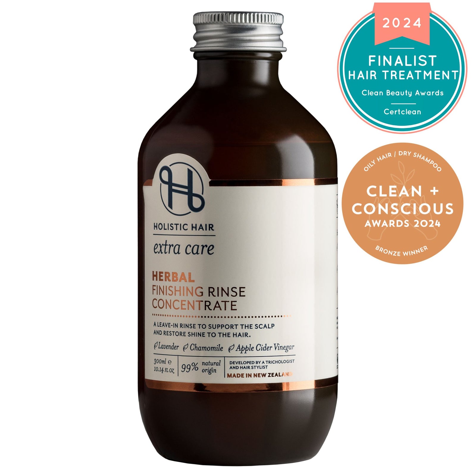 Bottle of leave-in rinse with apple cider vinegar, lavender sprigs, and chamomile flowers on a light background.