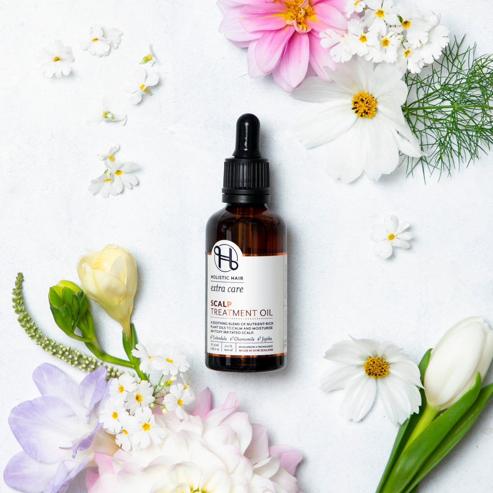 Image of Scalp Treatment Oil on a botanical background.